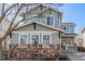 Close-up of charming two-story home featuring neutral siding, stone accents, and manicured front lawn at 12133 Hannibal St, Commerce City, CO 80603