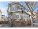 Two-story home with neutral siding and stone accents on corner lot with lush landscaped front yard at 12133 Hannibal St, Commerce City, CO 80603