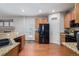 Bright kitchen featuring hardwood floors, wooden cabinets, and black appliances at 12133 Hannibal St, Commerce City, CO 80603
