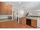 Kitchen featuring granite countertops, wooden cabinets, and stainless steel dishwasher at 12133 Hannibal St, Commerce City, CO 80603