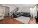 Cozy living room with hardwood floors, sectional sofa, staircase, and neutral paint at 12133 Hannibal St, Commerce City, CO 80603