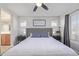 Lovely main bedroom with a ceiling fan and picture window that leads to a beautiful en suite bathroom at 12133 Hannibal St, Commerce City, CO 80603
