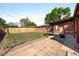 View of a fenced backyard featuring a small patio area with a fire pit and a wooden fence at 1560 Pueblo Ct, Thornton, CO 80229