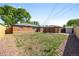 Wide shot of a fenced-in backyard with grass, a shed, landscaping and exterior of the house at 1560 Pueblo Ct, Thornton, CO 80229