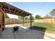 Wide view of the private backyard with a brick fire pit and an overhead pergola at 1560 Pueblo Ct, Thornton, CO 80229