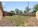 A spacious backyard is shown with a wooden fence, a shed, trees, and landscaping at 1560 Pueblo Ct, Thornton, CO 80229
