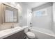 This updated bathroom features subway tile, newer fixtures, and a window for natural light at 1560 Pueblo Ct, Thornton, CO 80229