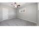 Bedroom featuring soft grey walls, neutral carpet, ceiling fan, and natural light from window at 1560 Pueblo Ct, Thornton, CO 80229