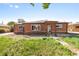 Quaint brick house featuring classic architecture, a covered entryway, and a mailbox by the sidewalk at 1560 Pueblo Ct, Thornton, CO 80229
