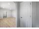 Hallway featuring arched doorway and view into bedroom with wood style floors at 1560 Pueblo Ct, Thornton, CO 80229