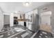 Updated kitchen featuring white cabinets, stainless steel appliances, and modern tile flooring at 1560 Pueblo Ct, Thornton, CO 80229