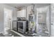 Spacious laundry room featuring modern washer and dryer, water heater, and storage cabinets at 1560 Pueblo Ct, Thornton, CO 80229