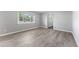 Inviting living room with modern flooring, gray walls, and a large window for ample natural light at 1560 Pueblo Ct, Thornton, CO 80229