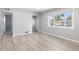 Well-lit living room featuring sleek flooring, neutral walls, and an open layout to the front entry at 1560 Pueblo Ct, Thornton, CO 80229