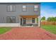 Wide backyard, including the covered patio with outdoor seating and grill, extends to the red mulch at 3343 S Newcombe St, Lakewood, CO 80227