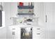 Modern dry bar with quartz countertop, display shelves, and a beverage fridge at 3343 S Newcombe St, Lakewood, CO 80227