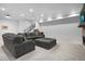 Bright basement featuring a large sectional, open staircase, and modern finishes for a cozy and inviting space at 3343 S Newcombe St, Lakewood, CO 80227