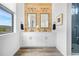 Elegant bathroom with a double vanity, wood accent wall, modern fixtures, and ample natural light at 3343 S Newcombe St, Lakewood, CO 80227