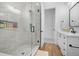 Walk-in shower features stunning tile work, rainfall shower head, and built-in niche for toiletries at 3343 S Newcombe St, Lakewood, CO 80227