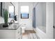 Modern bathroom with white subway tile, updated vanity, and bathtub with stylish shower curtain at 3343 S Newcombe St, Lakewood, CO 80227