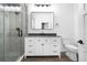 Modern bathroom features a glass enclosed shower with a mosaic tile accent wall, vanity with storage and fixtures at 3343 S Newcombe St, Lakewood, CO 80227