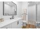 Modern bathroom featuring a walk-in shower with tile surround, vanity, and stylish fixtures at 3343 S Newcombe St, Lakewood, CO 80227