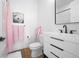 Elegant half-bathroom features modern fixtures, sleek vanity, and stylish decor with accent towels at 3343 S Newcombe St, Lakewood, CO 80227