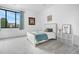 Cozy bedroom with natural light from large window, neutral carpet, and a comfortable bed at 3343 S Newcombe St, Lakewood, CO 80227