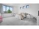 Bright bedroom with large window and multiple smaller windows provides lots of natural light at 3343 S Newcombe St, Lakewood, CO 80227