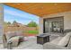 Inviting covered patio with comfortable seating and a fire pit, perfect for outdoor relaxation at 3343 S Newcombe St, Lakewood, CO 80227