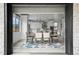 An exterior view into the kitchen and dining room is through sliding glass doors at 3343 S Newcombe St, Lakewood, CO 80227