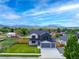 Stunning home exterior with modern design, a well-manicured lawn, and mountain views at 3343 S Newcombe St, Lakewood, CO 80227