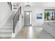 Bright foyer with wood floors, modern staircase, and a stylish front door at 3343 S Newcombe St, Lakewood, CO 80227