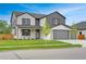 Attractive two-story home with a well-kept lawn, stylish gray accents, and a two car garage at 3343 S Newcombe St, Lakewood, CO 80227