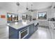 Gourmet kitchen features a large center island, stainless appliances, and quartz counters at 3343 S Newcombe St, Lakewood, CO 80227