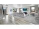 Inviting living room boasts a stone fireplace, large windows and plank flooring at 3343 S Newcombe St, Lakewood, CO 80227