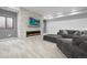 Cozy living room with stone fireplace, modern TV, and comfortable gray sofa at 3343 S Newcombe St, Lakewood, CO 80227