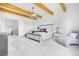 Bright and spacious main bedroom with wood beams, light gray furniture, and plush carpet at 3343 S Newcombe St, Lakewood, CO 80227