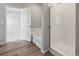 Elegant bathroom featuring a separate shower, a soaking tub, and wood flooring at 2165 Alyssa St, Fort Lupton, CO 80621