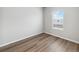 Bright bedroom with neutral walls, wood flooring, and a sunlit window at 2165 Alyssa St, Fort Lupton, CO 80621