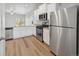 Modern kitchen featuring stainless steel appliances, granite countertops, and sleek white cabinetry at 2165 Alyssa St, Fort Lupton, CO 80621