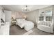 Bright bedroom featuring neutral tones, statement lighting, and a cozy seating area by the window at 6988 S Knolls Way, Centennial, CO 80122
