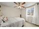 A simple bedroom with a ceiling fan and a large window, creating a relaxing atmosphere at 6988 S Knolls Way, Centennial, CO 80122