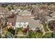 Charming two-story home with landscaped yard, inviting front porch, and visible neighborhood greenery at 6988 S Knolls Way, Centennial, CO 80122