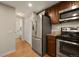 Kitchen with stainless steel appliances, ample cabinet space, and easy access to the downstairs half bath at 6988 S Knolls Way, Centennial, CO 80122