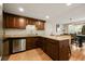 Spacious kitchen featuring stainless steel appliances, granite countertops, and an eat-in bar area at 6988 S Knolls Way, Centennial, CO 80122