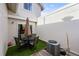 Enclosed patio with an outdoor dining set and well-maintained turf for relaxation at 6988 S Knolls Way, Centennial, CO 80122