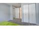 Grey bedroom with double doors leading to the bathroom at 14602 E 2Nd Ave # 100C, Aurora, CO 80011