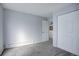 Simple bedroom with gray walls, carpet and white closet doors at 14602 E 2Nd Ave # 100C, Aurora, CO 80011