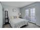 Second bedroom with grey bedding and access to patio at 14602 E 2Nd Ave # 100C, Aurora, CO 80011
